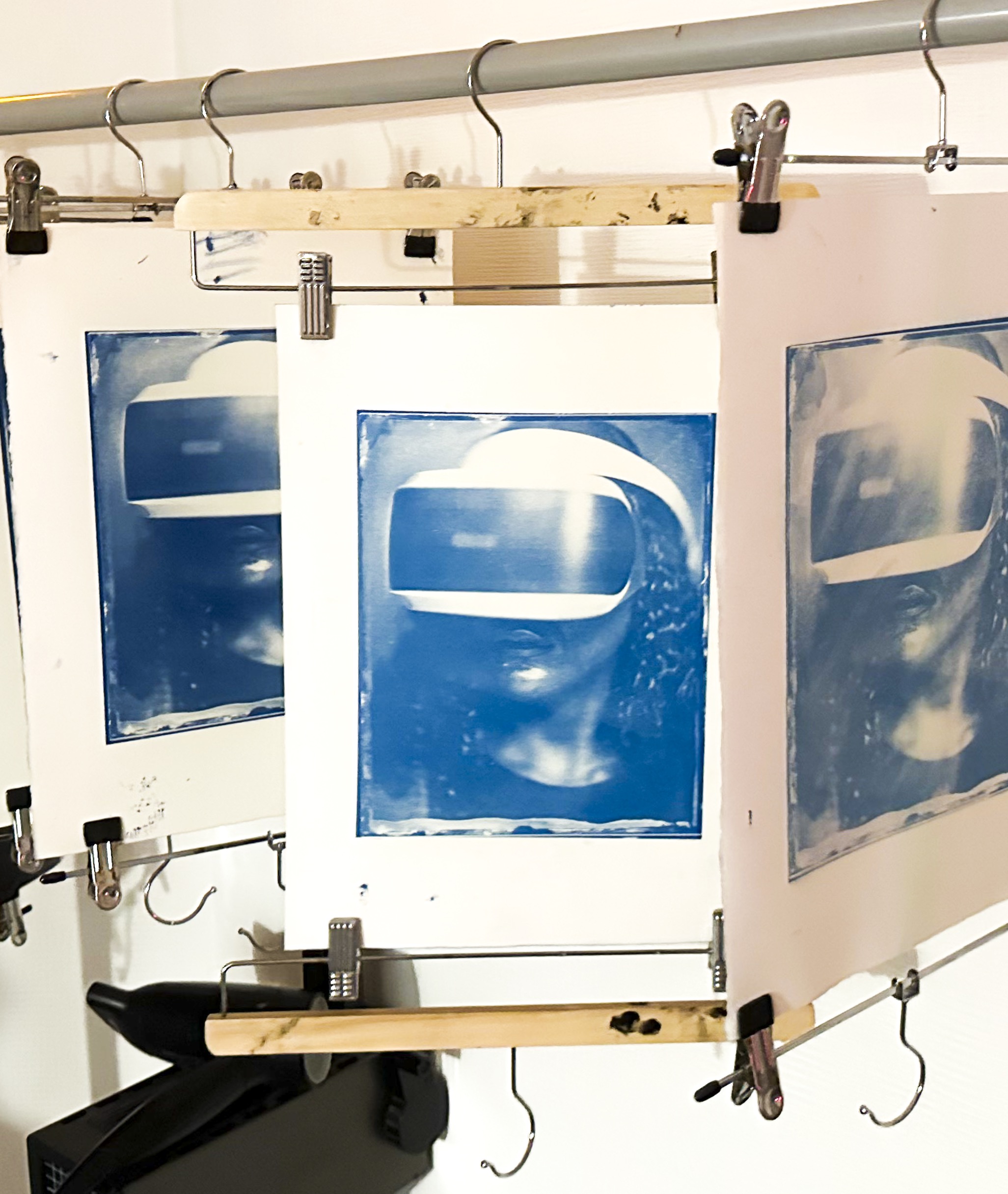 Cyanotype photographs hanging to dry in the studio